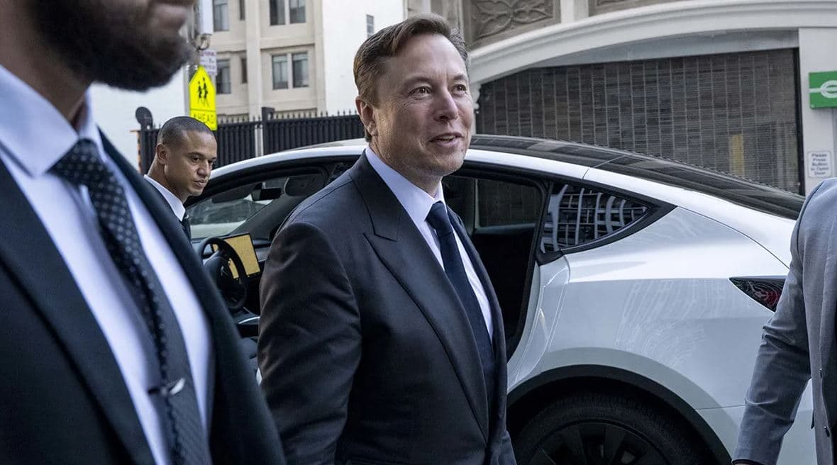 Elon Musk arriving outside a building during the SEC lawsuit over the 2018 funding secured Tesla tweet while serving as Tesla CEO.