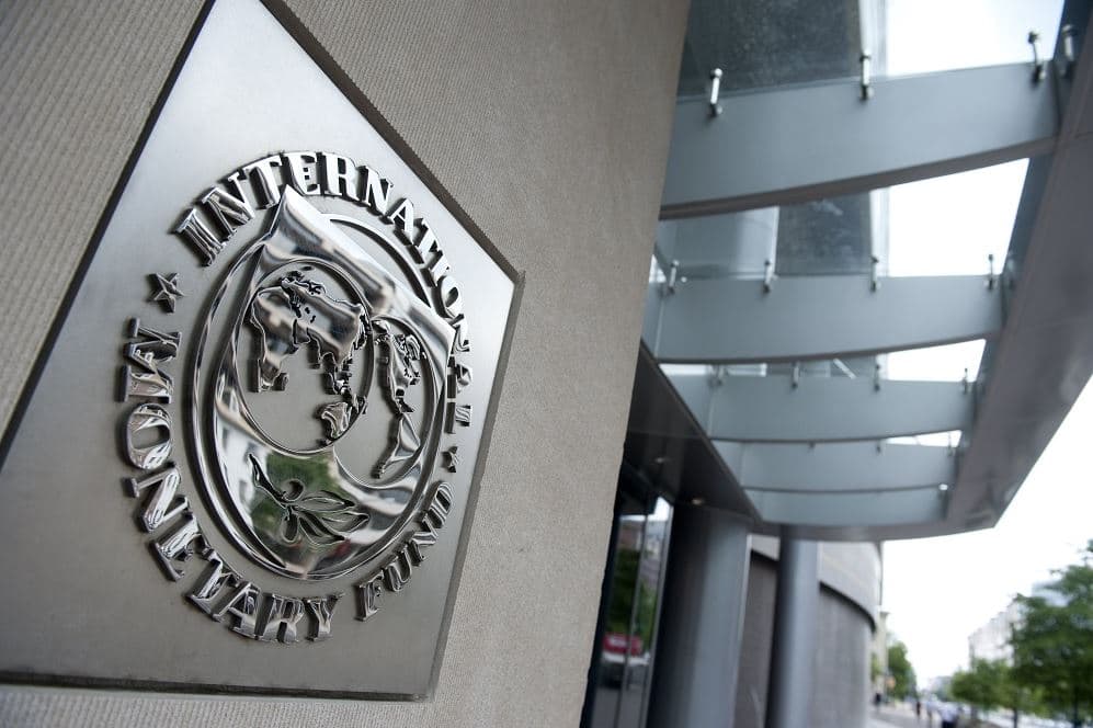 International Monetary Fund (IMF) headquarters sign displayed outside office building amid AI cybersecurity warning report