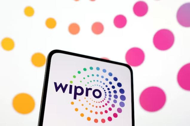 Wipro logo displayed on a smartphone screen with colorful circular branding elements, representing the company's expanding focus on artificial intelligence and digital transformation services.
